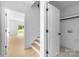 Hallway with open staircase and access to closet at 5125 Carden Dr, Charlotte, NC 28227