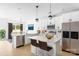 Bright, modern kitchen featuring white cabinets, stainless steel appliances, and a quartz island at 5125 Carden Dr, Charlotte, NC 28227