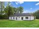 Expansive backyard with lush green grass and white siding on home at 5209 Carden Dr, Charlotte, NC 28227