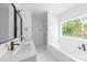 Large bathroom features double vanity, black accents, tiled shower, soaking tub and large window at 5209 Carden Dr, Charlotte, NC 28227