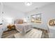 Bright bedroom with a neutral palette, featuring a large window and ample natural light at 5209 Carden Dr, Charlotte, NC 28227