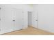 Bright, minimal bedroom with wood-look floors and double closets, freshly painted white at 5209 Carden Dr, Charlotte, NC 28227