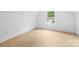 Bedroom with modern wood-look floors and natural light coming in from one window at 5209 Carden Dr, Charlotte, NC 28227