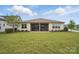 Well-manicured backyard with lush green lawn, screened-in porch, and mature landscaping for serene outdoor living at 5247 Looking Glass Trl, Denver, NC 28037