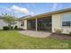 Charming backyard featuring a screened-in porch, brick patio, and lush green lawn for outdoor enjoyment at 5247 Looking Glass Trl, Denver, NC 28037