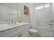 Bright bathroom featuring white fixtures and a shower-tub combo with curtain at 5247 Looking Glass Trl, Denver, NC 28037