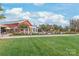 Exterior view of a clubhouse with manicured lawn and patio seating, perfect for gatherings at 5247 Looking Glass Trl, Denver, NC 28037