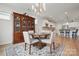 Bright dining area with a modern light fixture, hardwood floors, and access to the kitchen at 5247 Looking Glass Trl, Denver, NC 28037