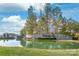 Elegant community entrance sign reflected in a serene pond with mature trees in the background at 5247 Looking Glass Trl, Denver, NC 28037