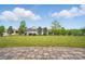 Beautifully landscaped front yard with lush green lawn, mature trees, and charming curb appeal at 5247 Looking Glass Trl, Denver, NC 28037
