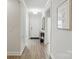 Bright hallway with modern flooring, art and a view to the front door at 5247 Looking Glass Trl, Denver, NC 28037
