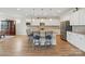 Bright, open kitchen with an island bar, stainless appliances, and ample cabinet space for storage at 5247 Looking Glass Trl, Denver, NC 28037