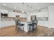 Spacious kitchen featuring a large center island with seating, stainless steel appliances, and sleek countertops at 5247 Looking Glass Trl, Denver, NC 28037