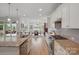Modern kitchen featuring granite countertops, stainless steel appliances, and a view into the dining area at 5247 Looking Glass Trl, Denver, NC 28037