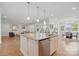 Modern kitchen island with stainless steel dishwasher, open layout to a stylish living and dining area at 5247 Looking Glass Trl, Denver, NC 28037