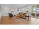Inviting living room featuring hardwood floors, neutral paint, stylish furnishings and sliding glass doors at 5247 Looking Glass Trl, Denver, NC 28037