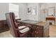 Office with a grand wooden desk and leather chair, complemented by natural light at 5247 Looking Glass Trl, Denver, NC 28037