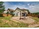 A beautiful backyard featuring a stone fire pit, patio, and lawn area, perfect for entertaining and outdoor enjoyment at 6001 Pine Cone Ln, Monroe, NC 28110