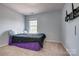 Neat bedroom showcasing great potential with a wall-mounted television and neutral colored walls, perfect for comfort at 6001 Pine Cone Ln, Monroe, NC 28110