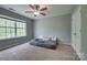 Tranquil bedroom featuring a large window, ceiling fan, and ample space, ideal for relaxation and rest at 6001 Pine Cone Ln, Monroe, NC 28110