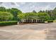 Well-maintained clubhouse surrounded by lush landscaping and ample parking for residents and guests at 6001 Pine Cone Ln, Monroe, NC 28110