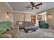 Spacious living area with neutral tones, ceiling fan, and open layout flowing into the kitchen, ideal for modern living at 6001 Pine Cone Ln, Monroe, NC 28110