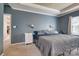 Serene main bedroom featuring a tray ceiling, soft lighting, and access to a private en-suite bathroom at 6001 Pine Cone Ln, Monroe, NC 28110