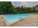 Large community pool with plenty of deck space and surrounded by mature trees at 6001 Pine Cone Ln, Monroe, NC 28110