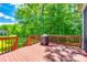 Spacious backyard deck featuring wood flooring, wooden railing, and a portable barbeque smoker at 618 Chase Ct, Fort Mill, SC 29708