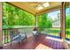 Cozy screened-in back porch with ceiling fan, outdoor furniture, and views of lush greenery at 618 Chase Ct, Fort Mill, SC 29708