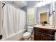Cozy bathroom featuring a tub with shower, vanity with dark wood cabinets, and a window offering natural light at 618 Chase Ct, Fort Mill, SC 29708