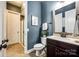 Bathroom features a vanity, toilet, blue accent wall, framed art, and a glass-enclosed shower at 618 Chase Ct, Fort Mill, SC 29708