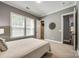 This carpeted bedroom offers windows for natural light and access to the bathroom and walk-in closet at 618 Chase Ct, Fort Mill, SC 29708