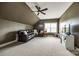 Comfortable bonus room with plush carpeting, ceiling fan, and a large sectional sofa at 618 Chase Ct, Fort Mill, SC 29708