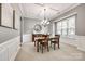 Formal dining room with coffered ceiling, wainscoting, large window, and decorative light fixture at 618 Chase Ct, Fort Mill, SC 29708