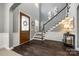 Elegant foyer with hardwood floors, staircase, and decorative front door with lots of detail at 618 Chase Ct, Fort Mill, SC 29708