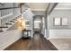 Open foyer featuring hardwood floors, arched doorways, white trim, and staircase at 618 Chase Ct, Fort Mill, SC 29708