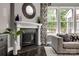 Living room features a fireplace with a custom mantel and large windows at 618 Chase Ct, Fort Mill, SC 29708