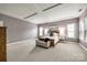 Bright primary bedroom with tray ceilings, natural light, and neutral colored walls at 618 Chase Ct, Fort Mill, SC 29708