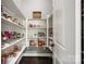 Walk-in pantry with wooden floors, white shelving, and plenty of storage space at 618 Chase Ct, Fort Mill, SC 29708