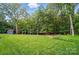 Lush backyard with a shed and a cleared area at 6508 Trenton Pl, Charlotte, NC 28226