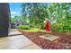 Beautiful backyard features modern landscaping, mature trees, and unique outdoor decor, creating a serene retreat at 6508 Trenton Pl, Charlotte, NC 28226