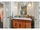 Stylish bathroom vanity with wood cabinets, modern sink, and a chic mirror at 6508 Trenton Pl, Charlotte, NC 28226
