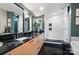 Modern bathroom with dual sinks, black marble countertop, and a sleek glass-enclosed shower with dual shower heads at 6508 Trenton Pl, Charlotte, NC 28226
