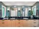Bright bathroom featuring dual sinks with black marble countertop, stylish lighting fixtures, and decorative accents at 6508 Trenton Pl, Charlotte, NC 28226