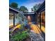 Picturesque courtyard with lush greenery, modern rock garden, and exterior views of the home at 6508 Trenton Pl, Charlotte, NC 28226