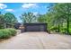 Spacious driveway leads to a modern home with a sleek garage and lush landscaping, offering both convenience and beauty at 6508 Trenton Pl, Charlotte, NC 28226
