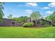 Lush green lawn surrounds a modern home with expansive windows, providing natural light and scenic outdoor views at 6508 Trenton Pl, Charlotte, NC 28226