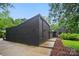 Modern home showcases clean lines, dark brick exterior, and stylish landscaping, highlighting its contemporary design at 6508 Trenton Pl, Charlotte, NC 28226