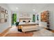 A bright main bedroom features a unique decor style, a ceiling fan, and access to the en suite bathroom at 6508 Trenton Pl, Charlotte, NC 28226